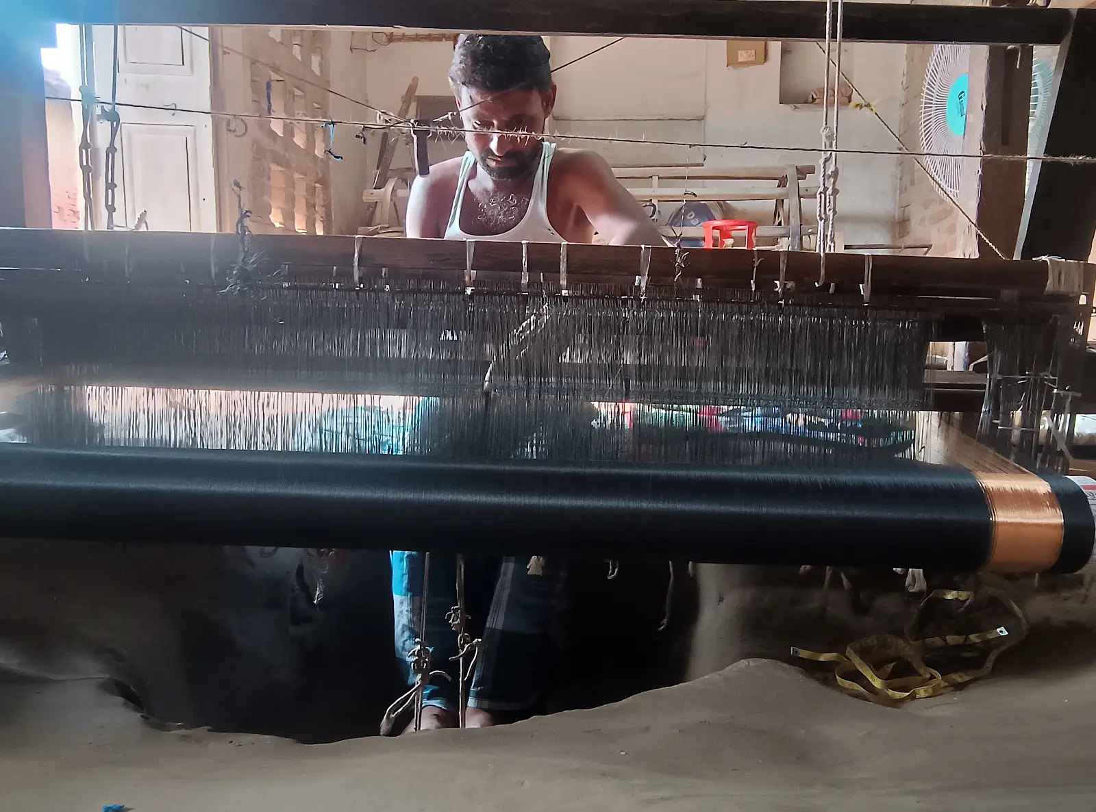 Home Bhagalpur artisan weaving silk on a traditional handloom